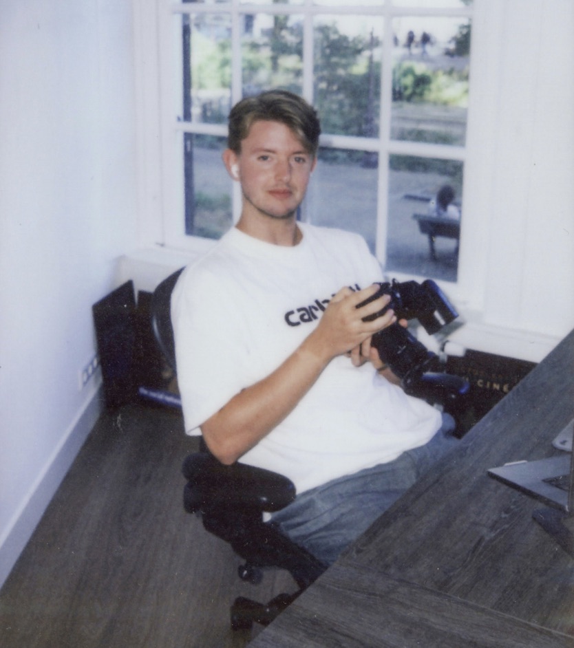 jens sitting by the window with his camera
