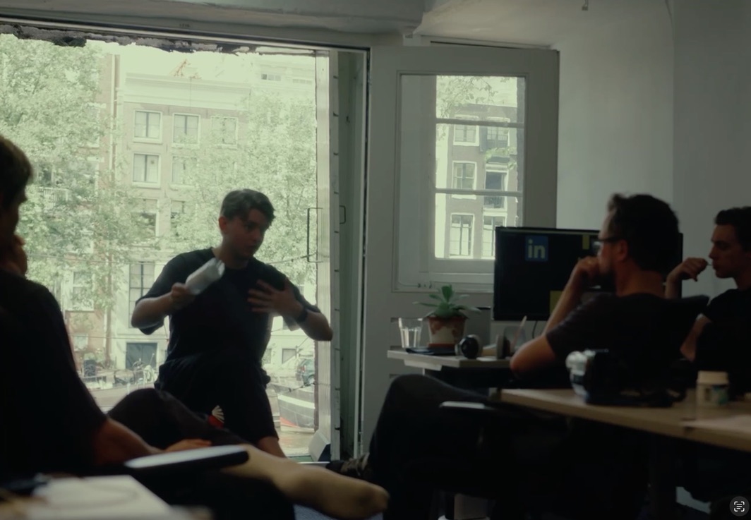 a group discussion in the canal-facing office
