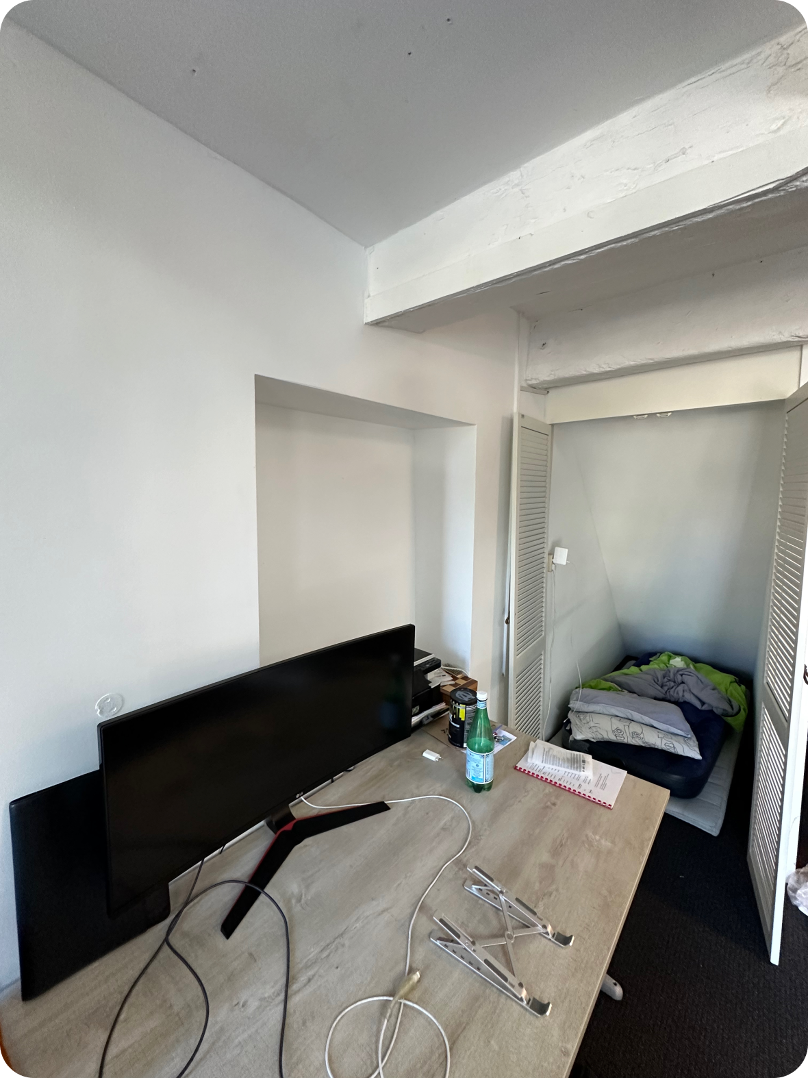 a desk beside the cupboard where i slept in the office