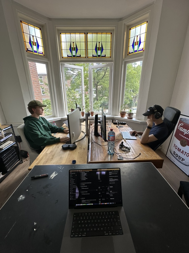 working across a shared desk beneath stained-glass windows