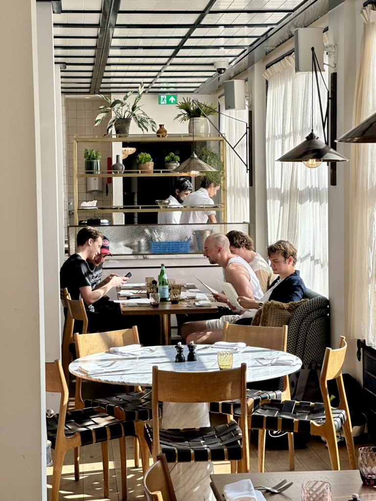 friends looking through menus around a restaurant table